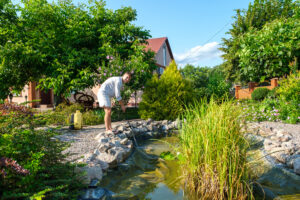 Cleaning the bottom of the pond.